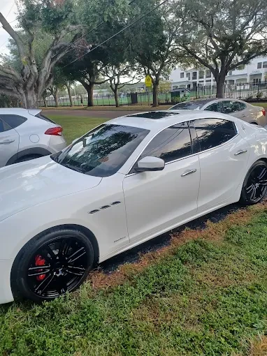 White Maserati detailed in a sunny residential driveway
