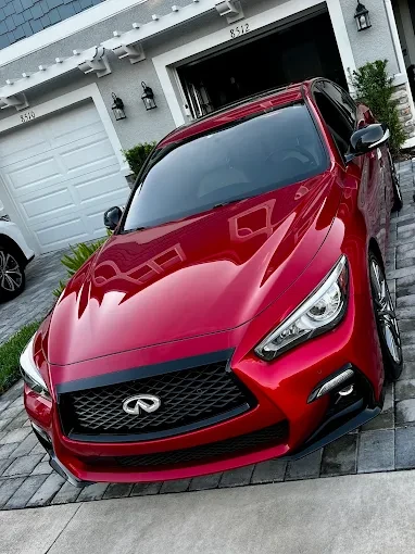 Detailed red Infiniti parked in a driveway